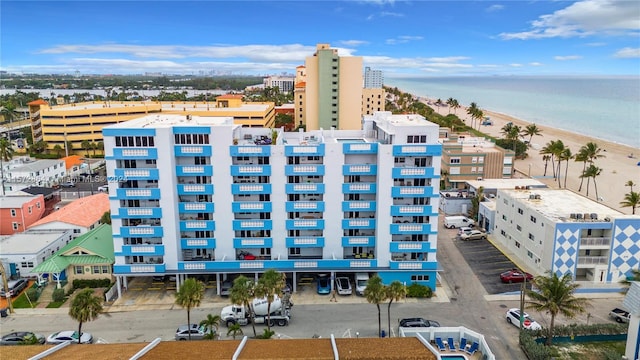 drone / aerial view featuring a beach view and a water view