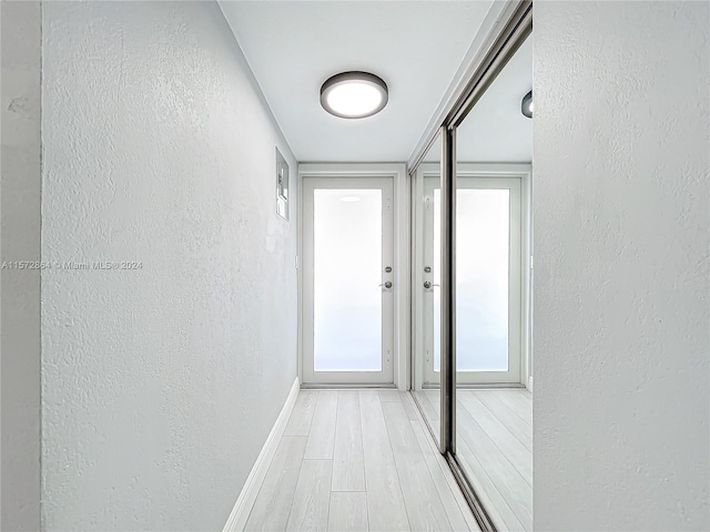 hallway with light hardwood / wood-style flooring