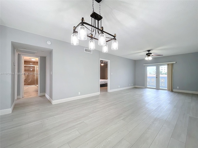 spare room with ceiling fan and light wood-type flooring