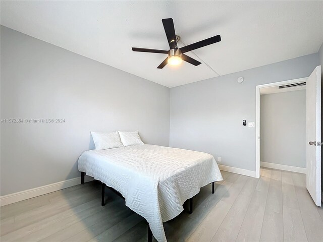 bedroom with ceiling fan and light hardwood / wood-style flooring