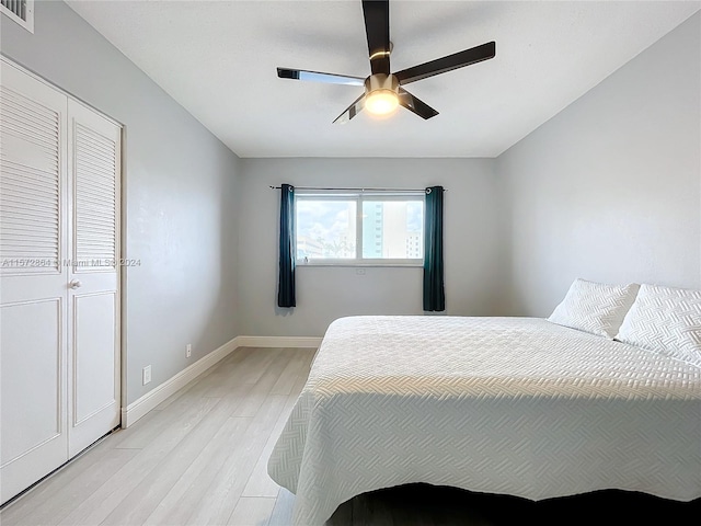 bedroom featuring a closet, ceiling fan, and light hardwood / wood-style floors