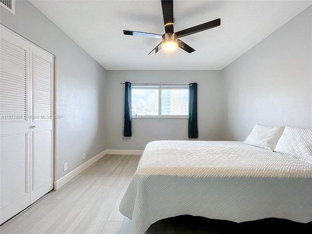 bedroom with ceiling fan and light hardwood / wood-style flooring