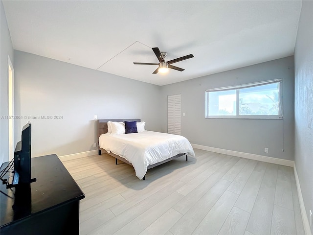 bedroom with light hardwood / wood-style flooring and ceiling fan