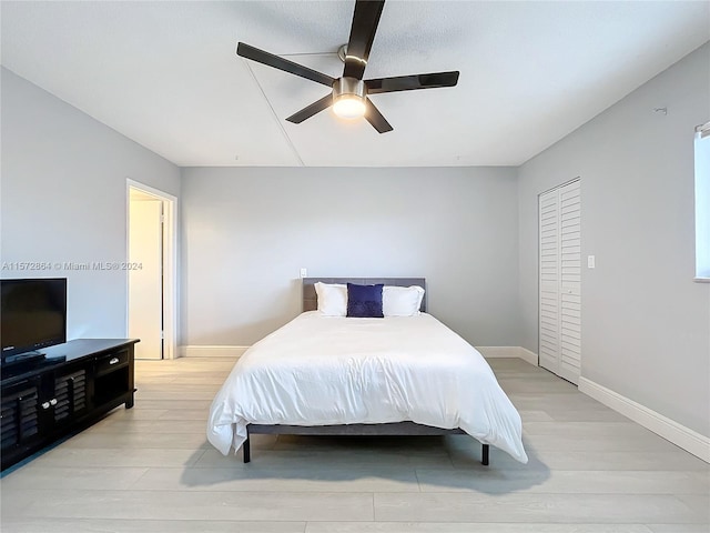 bedroom with ceiling fan and light wood-type flooring