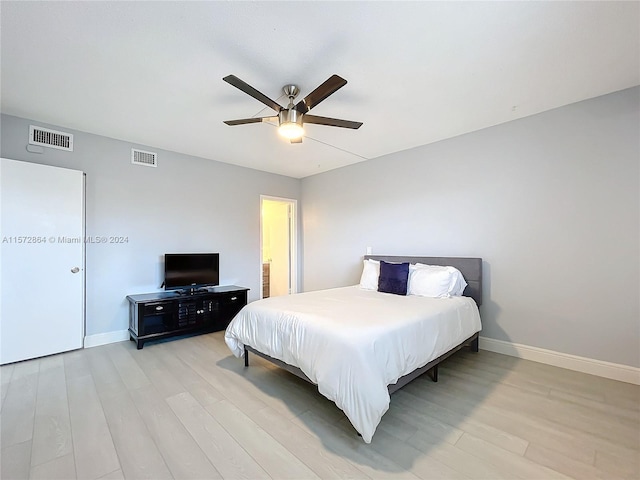 bedroom with ceiling fan and light hardwood / wood-style floors