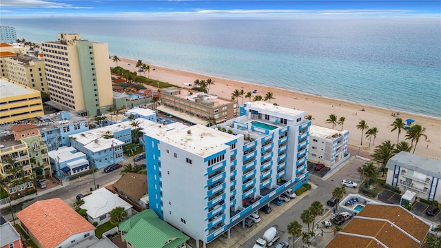 aerial view with a water view and a beach view