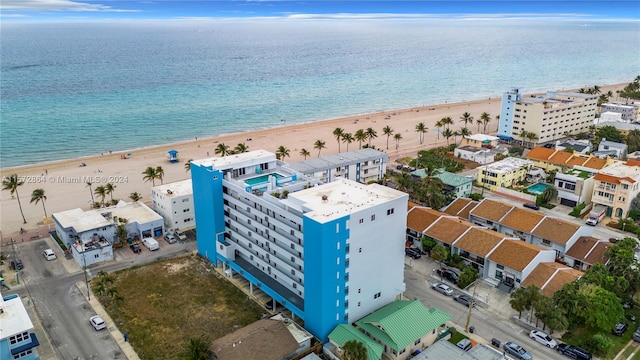 drone / aerial view with a beach view and a water view