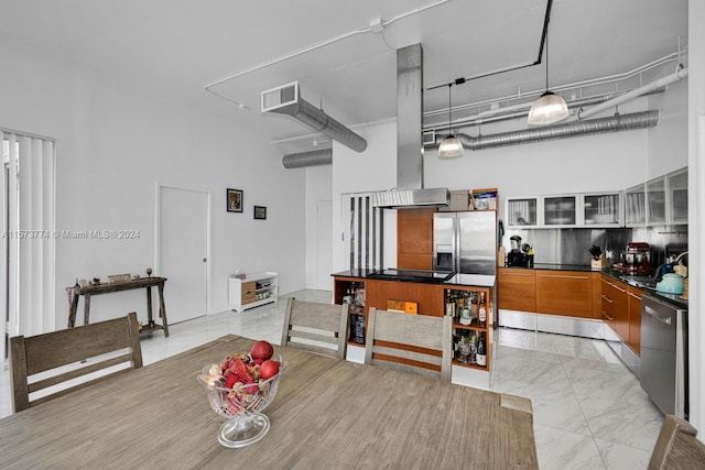 tiled dining area featuring a towering ceiling