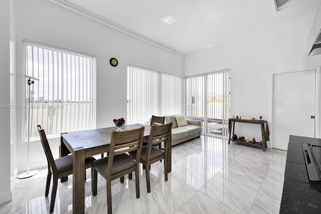 dining area featuring light tile floors