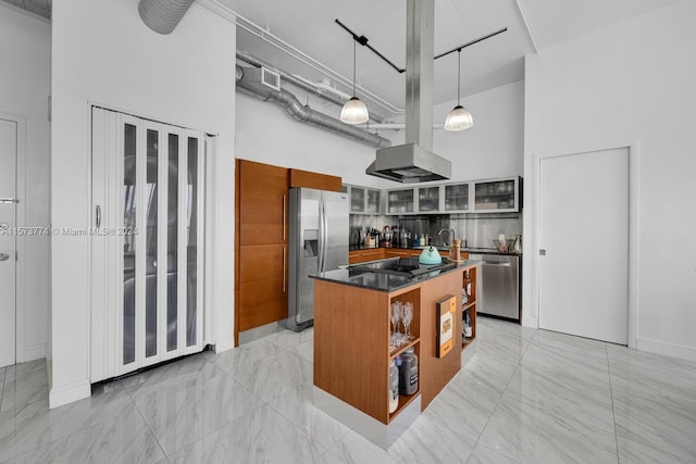 kitchen featuring a center island, decorative light fixtures, a high ceiling, appliances with stainless steel finishes, and light tile floors