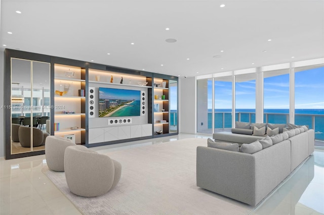 tiled living room featuring a water view and floor to ceiling windows