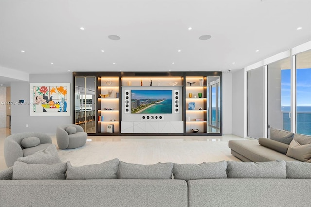 living room with expansive windows and a water view