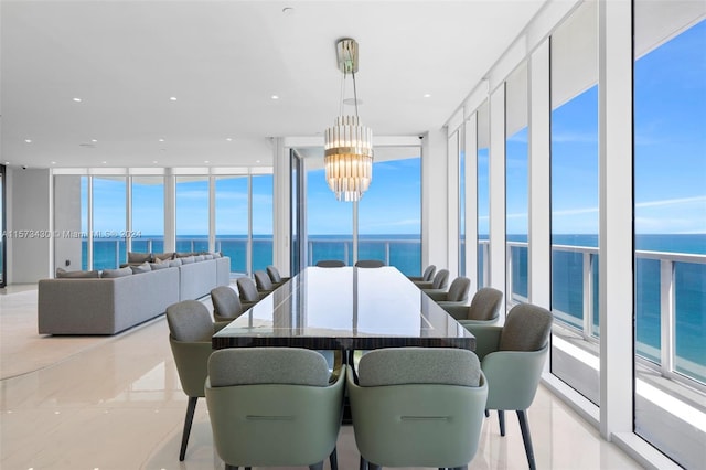 tiled dining area with a water view, a wall of windows, and a chandelier