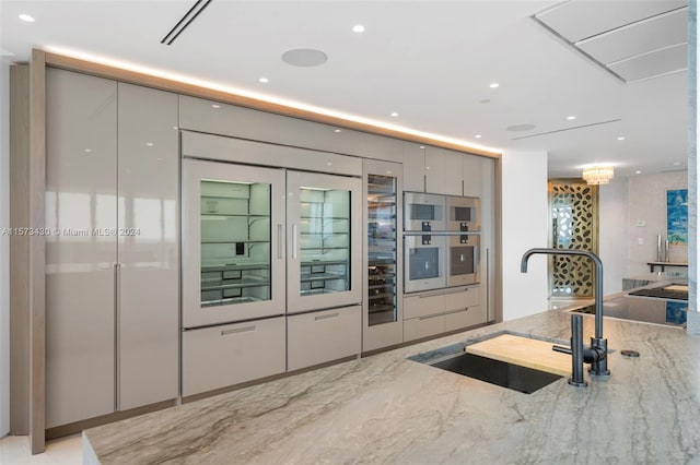 kitchen featuring sink and light stone counters