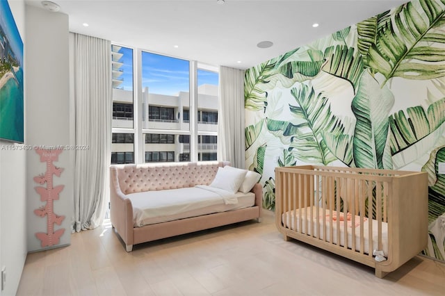 sitting room featuring hardwood / wood-style flooring and expansive windows