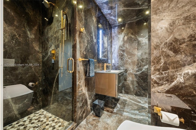 bathroom with tile walls, vanity, and a shower with shower door