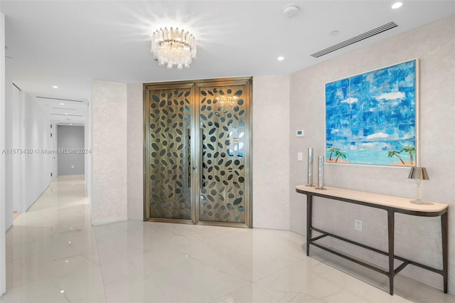 corridor featuring tile floors and an inviting chandelier