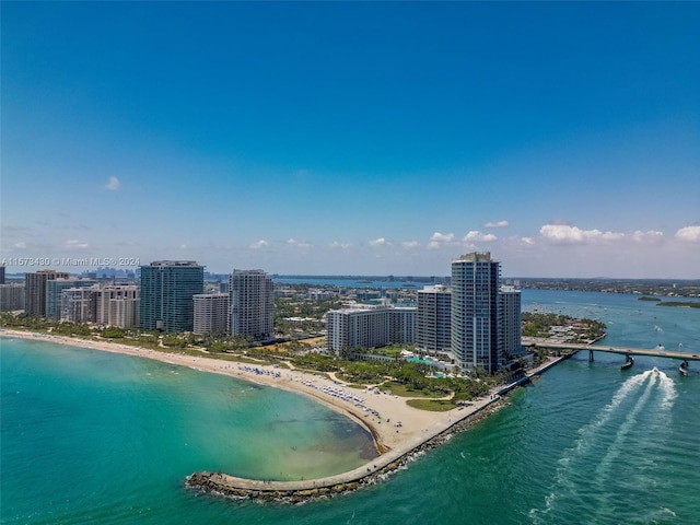 birds eye view of property featuring a water view and a beach view