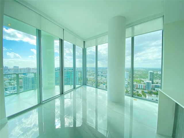 tiled spare room with expansive windows