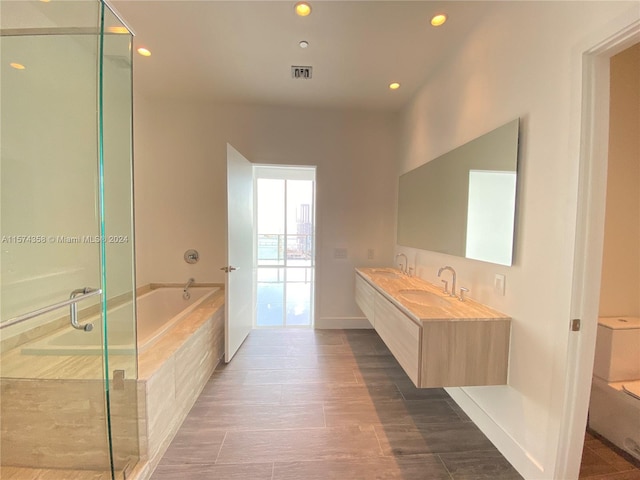 bathroom with independent shower and bath and vanity