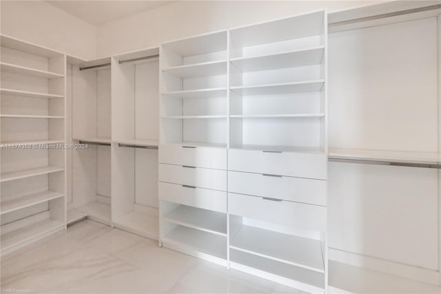 walk in closet featuring light tile flooring