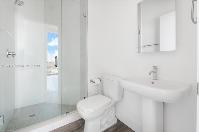 bathroom featuring an enclosed shower and toilet