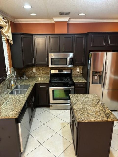 kitchen featuring ornamental molding, tasteful backsplash, and appliances with stainless steel finishes