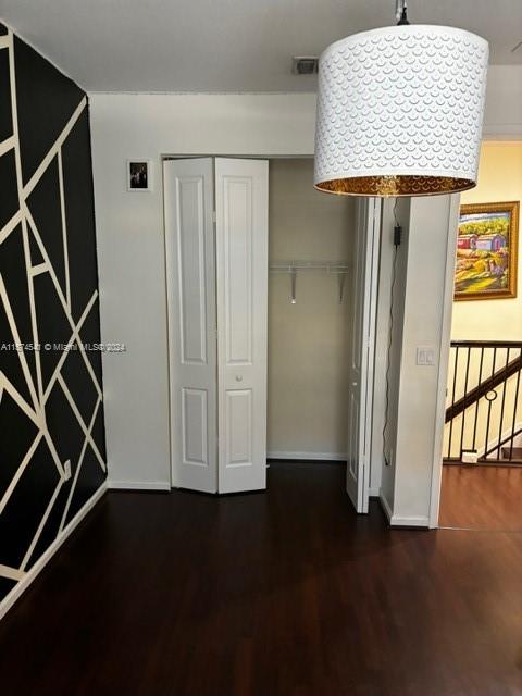 hall featuring dark wood-type flooring