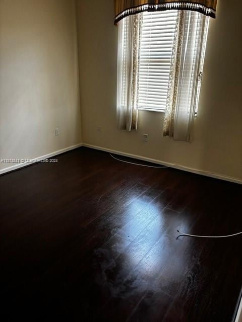 empty room with hardwood / wood-style flooring