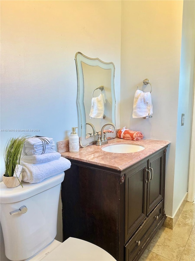 bathroom featuring tile patterned floors, vanity, and toilet