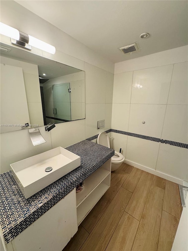 bathroom featuring hardwood / wood-style floors, vanity, and toilet