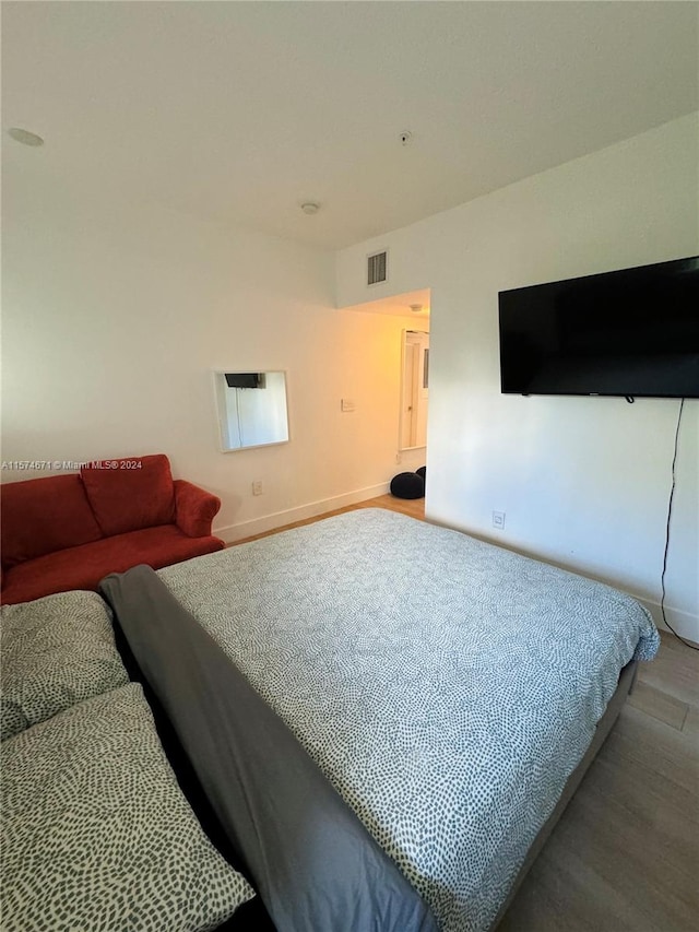 bedroom with wood-type flooring