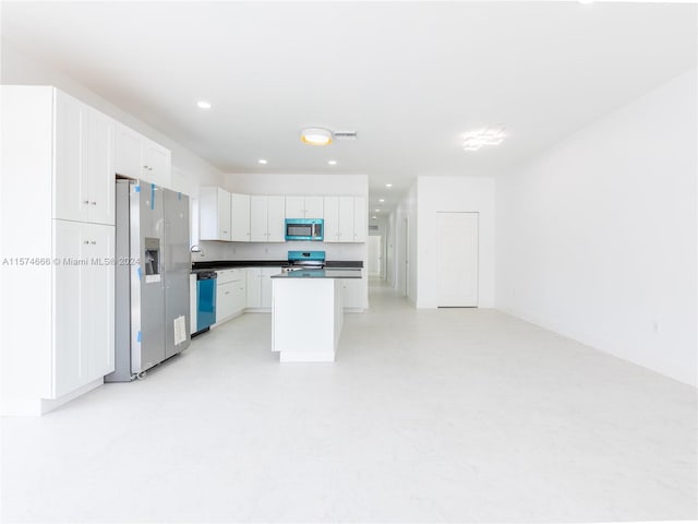 kitchen with white cabinetry, appliances with stainless steel finishes, and a center island