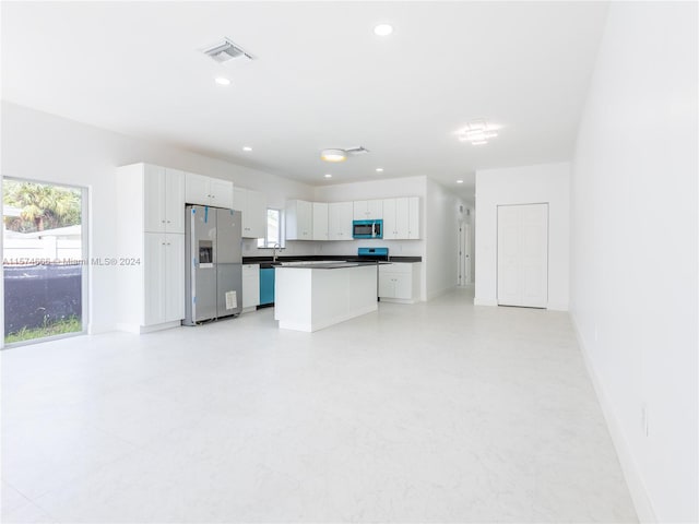 kitchen featuring a kitchen island, appliances with stainless steel finishes, and white cabinetry