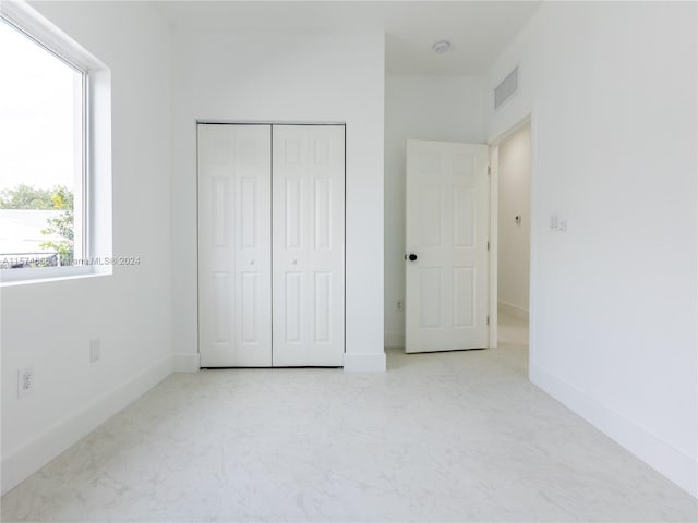 unfurnished bedroom with a closet