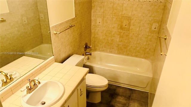 full bathroom with tile patterned flooring, vanity, tiled shower / bath combo, and toilet