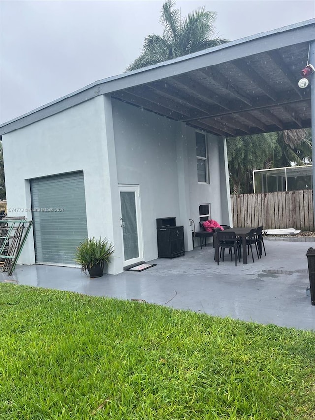 exterior space featuring a lawn and a carport