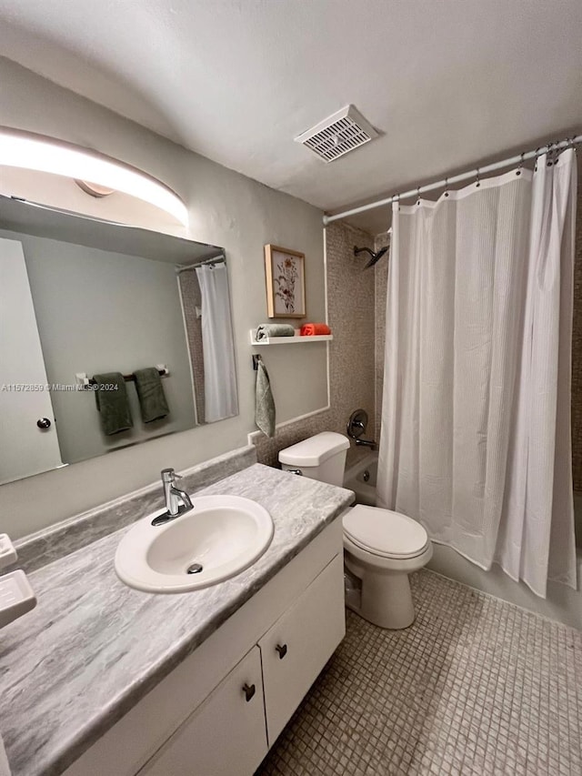 full bathroom featuring vanity with extensive cabinet space, toilet, tile flooring, and shower / tub combo with curtain