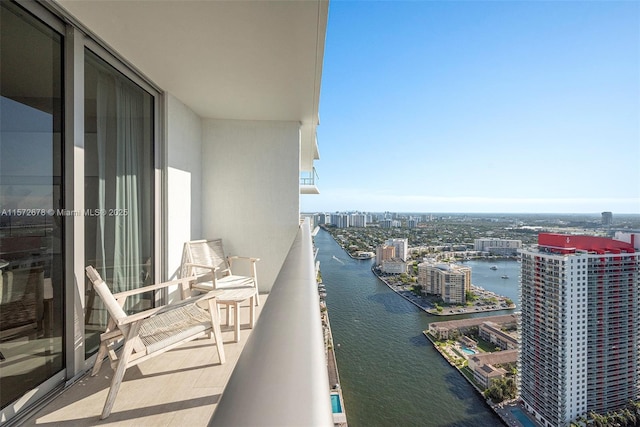 balcony featuring a view of city and a water view