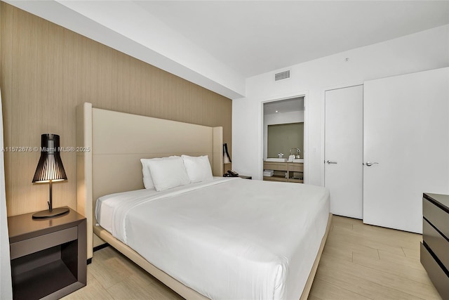 bedroom featuring visible vents and light wood-style flooring