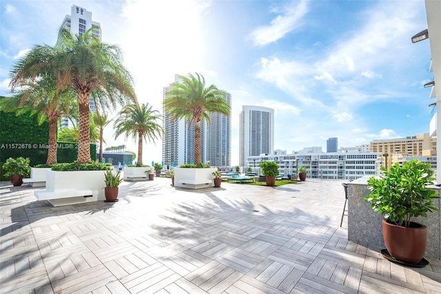 view of home's community with a patio area and a city view