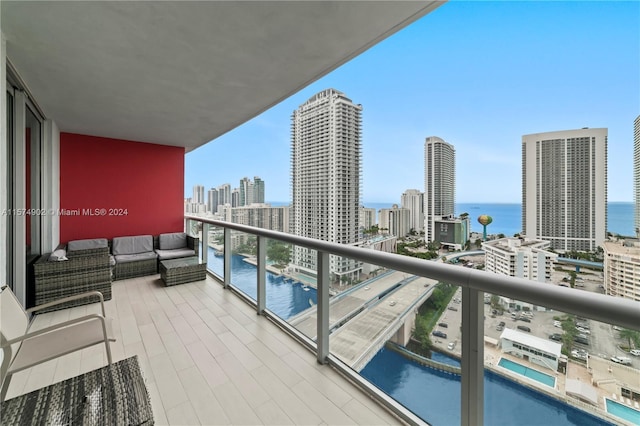 balcony featuring a water view and an outdoor hangout area