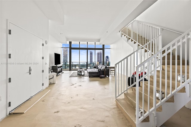 bedroom featuring multiple windows, a water view, and expansive windows