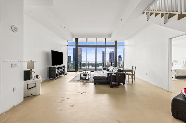 carpeted bedroom with floor to ceiling windows and a water view