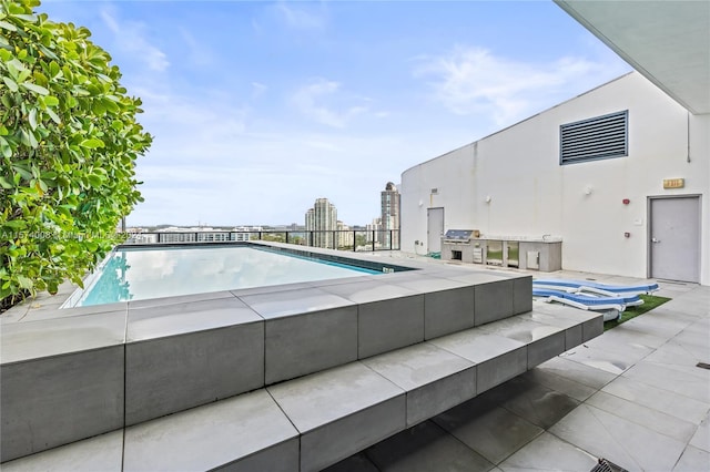 view of swimming pool featuring a patio area