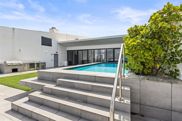 view of swimming pool featuring a patio and area for grilling