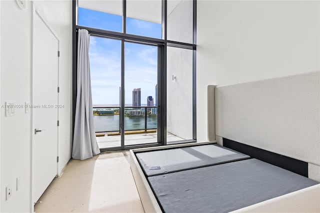 unfurnished bedroom with multiple windows and a water view