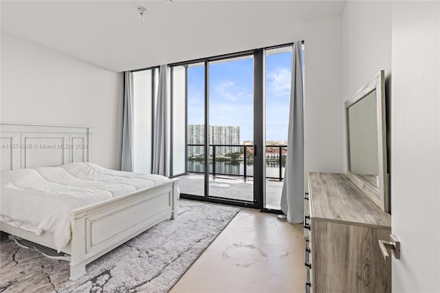 bedroom featuring concrete flooring and access to outside