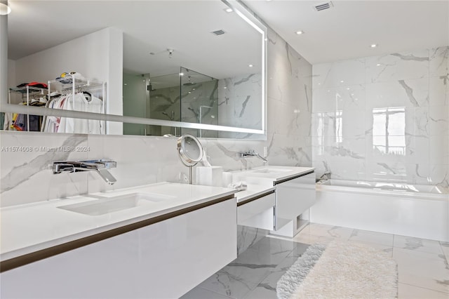 bathroom featuring tile flooring, double vanity, and tile walls