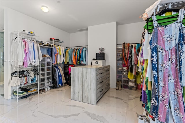 spacious closet with light tile floors